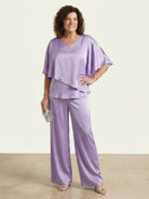 Woman wearing elegant layers two-piece set with V-neck and flared sleeves in a soft fabric