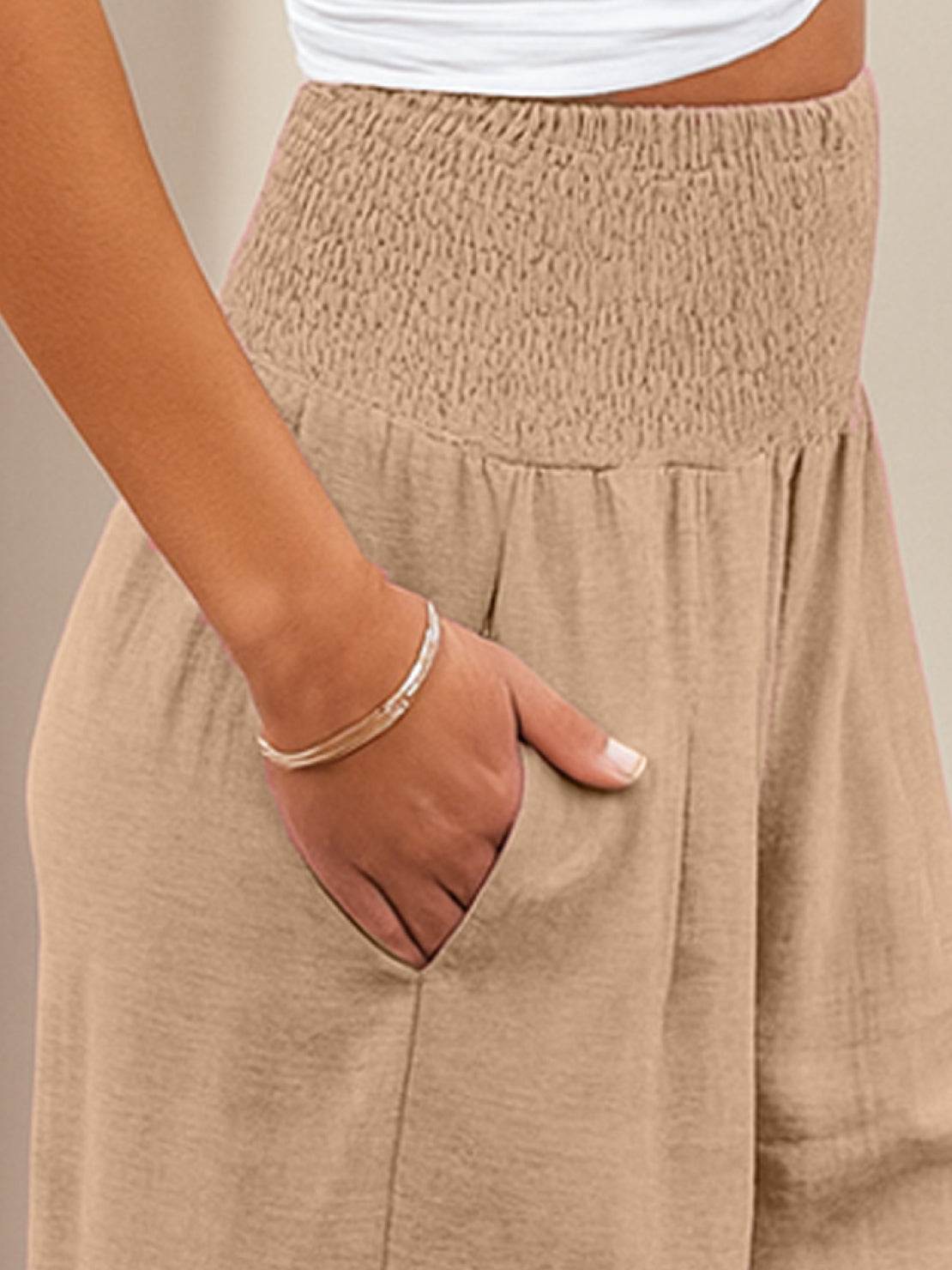 Close-up of beige high-waist cotton linen palazzo pants with pocket and smocked waistband