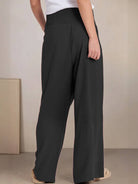 Woman wearing black high-waist cotton linen palazzo pants with wide legs and smocked waistband