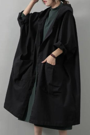 Oversized black waterproof windbreaker jacket with hood and large front pockets, one size fits all design