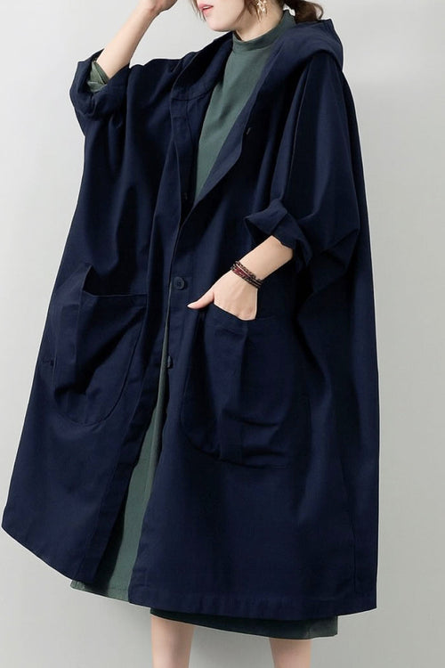 Oversized water-resistant windbreaker jacket with waterproof design, attached hood, snap-button closure, and large pockets.