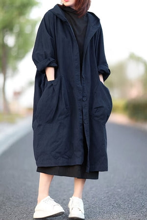 Oversized navy water-resistant windbreaker jacket with hood and large pockets, lightweight waterproof design.