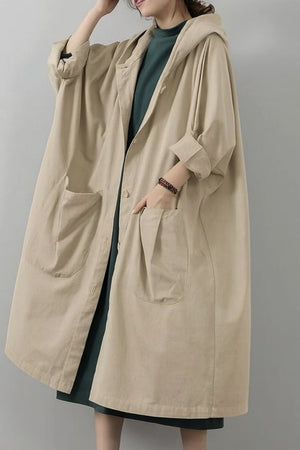 Oversized beige water-resistant windbreaker jacket with hood and large front pockets, lightweight waterproof design.
