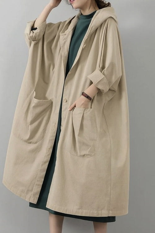 Oversized beige water-resistant windbreaker jacket with hood and large front pockets, lightweight waterproof design.