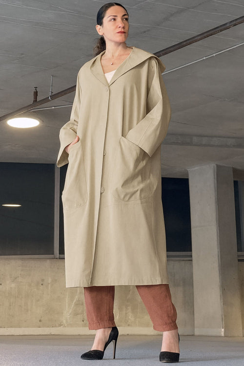Oversized beige water-resistant windbreaker jacket with waterproof design and attached hood