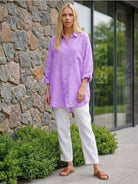 Oversized linen shirt in white with relaxed fit and back button detailing
