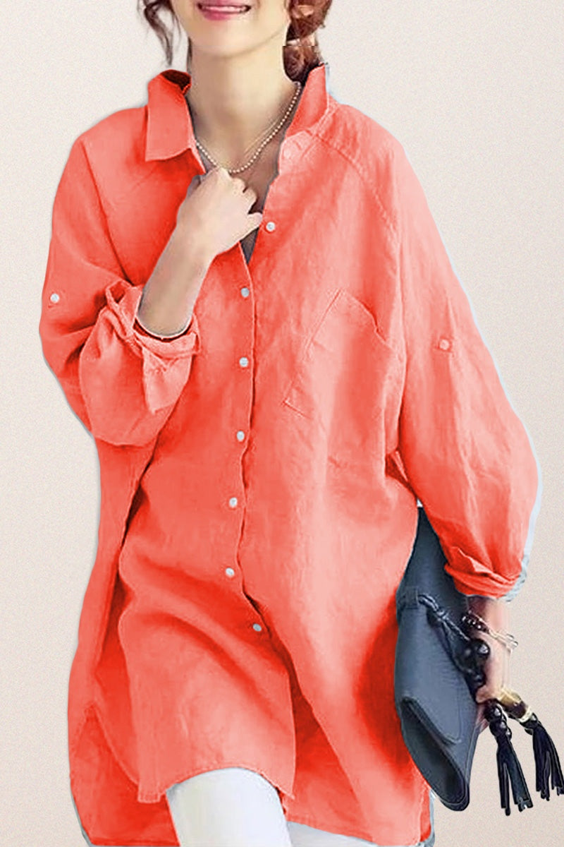 Coral oversized linen shirt with relaxed fit and button details, styled casually with rolled sleeves and a black clutch bag