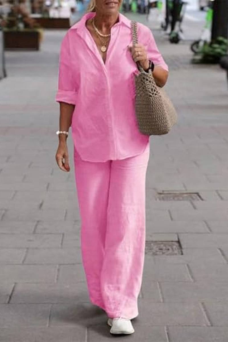 Woman wearing oversized 100% cotton pink shirt and wide-leg pants co-ord set walking outdoors