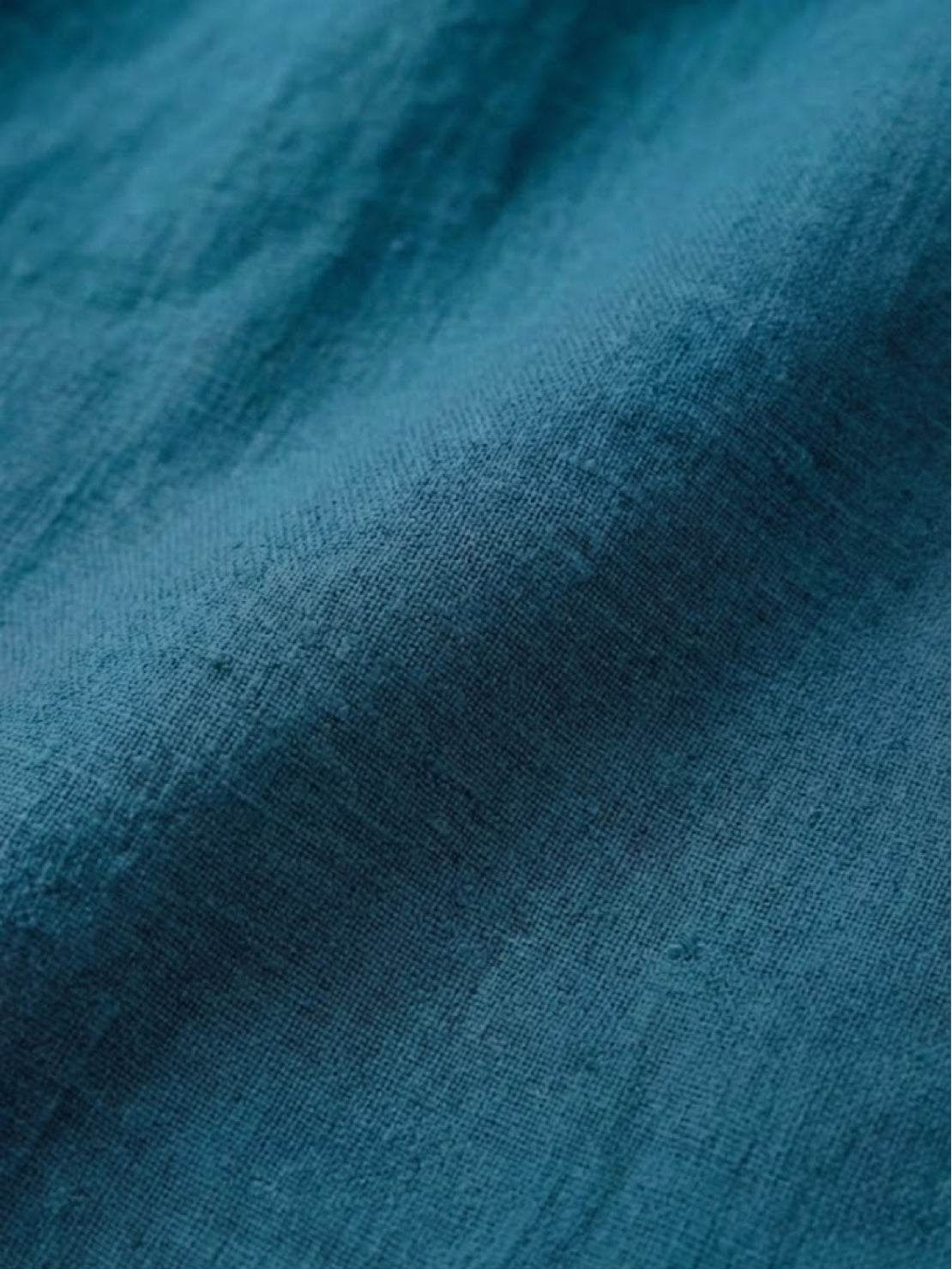 close-up of relaxed loose breathable linen fabric in blue texture