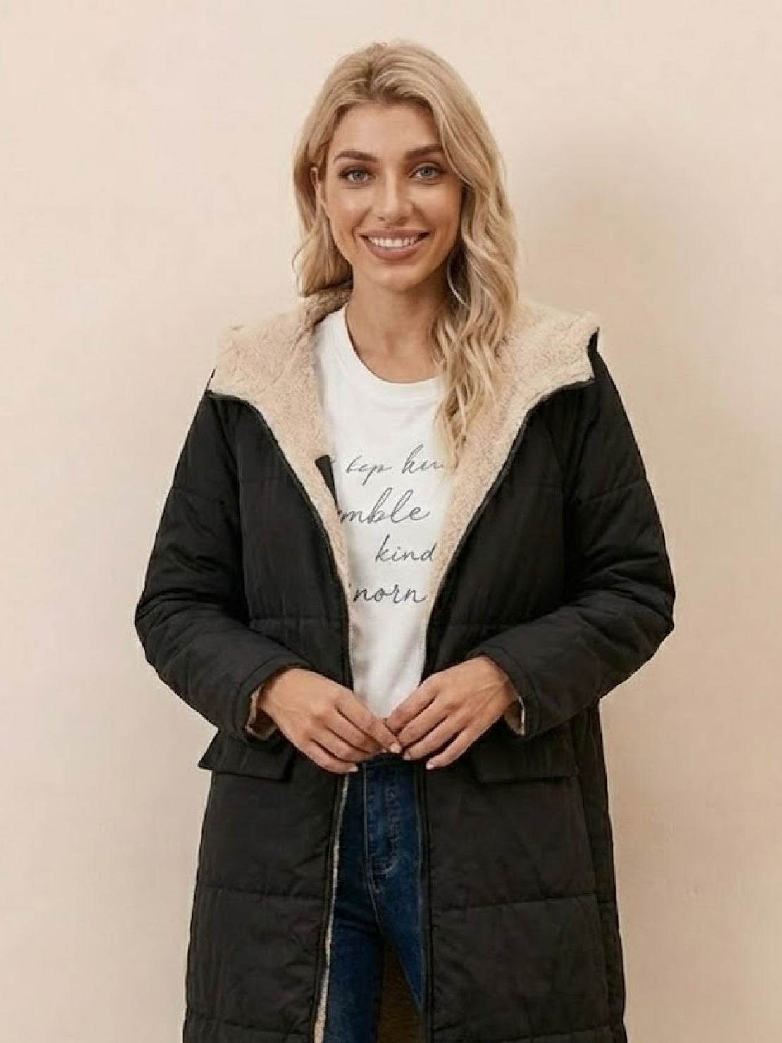 Woman wearing black Sherpa-lined hooded teddy coat with cozy sherpa interior and front pockets