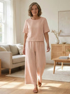 Loose fit co-ord set featuring a soft-tailored top with wide short sleeves and wide-leg bottoms in breathable fabric.