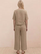 Woman wearing a soft-tailored top and wide-leg trousers from the loose fit co-ord set in a relaxed style