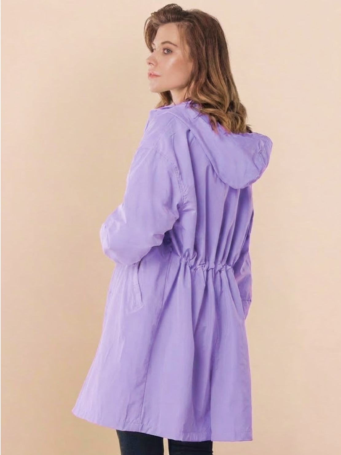 Stylish oversized lavender Rain Couture Windbreaker with adjustable hood and cinched waist, lightweight and water-resistant.