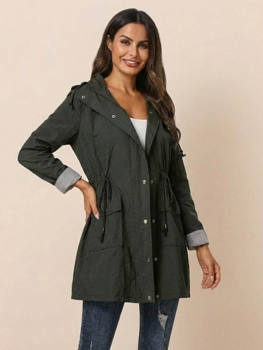 woman wearing water resistant hooded striped windbreaker rain jacket black front view