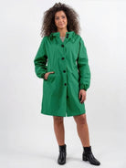 Water-resistant oversized hooded windbreaker rain jacket on model outdoors