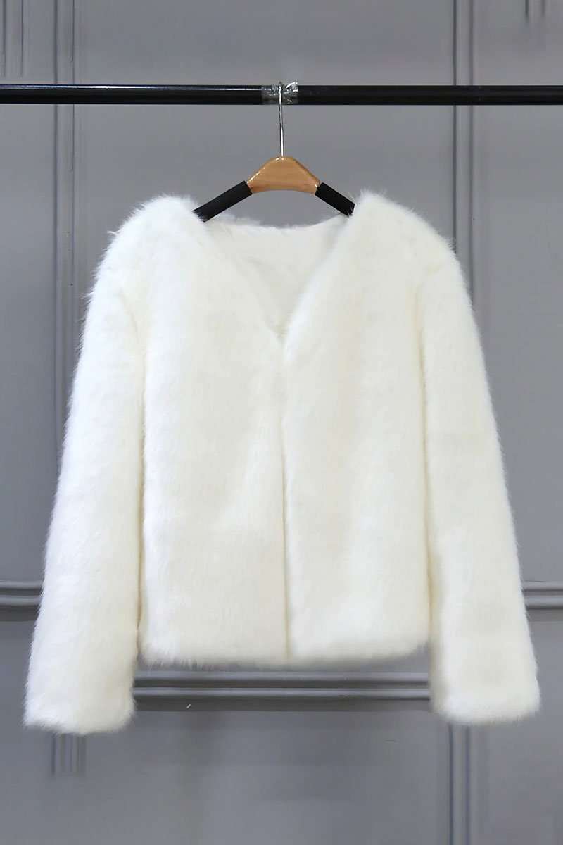 white bold faux fur luxe jacket with V neckline and button front closure hanging on wooden hanger